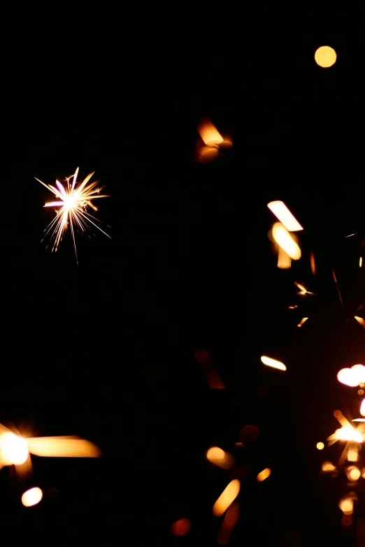 a close up of a sparkler in the dark, pexels, light and space, confetti, taken in the late 2000s, illustration, star sparkle