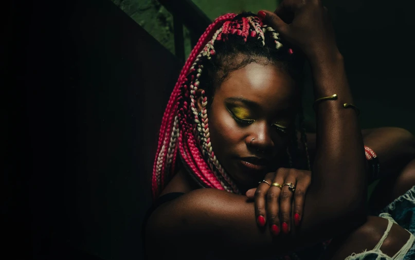 a woman with dreadlocks posing for a picture, inspired by Ras Akyem, trending on pexels, afrofuturism, braided hair. nightime, green and pink, ebony skin, a lonely woman