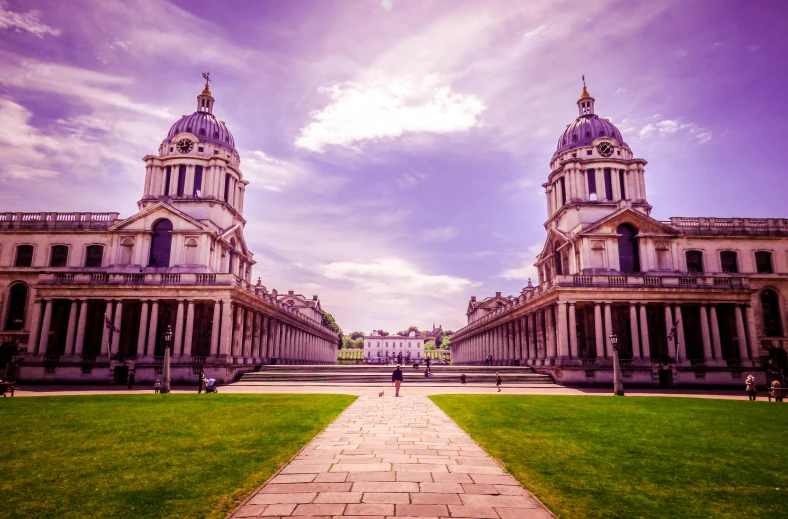 a couple of large buildings sitting on top of a lush green field, inspired by Christopher Wren, pexels contest winner, mannerism, purple, square, national gallery, elegant walkways between towers