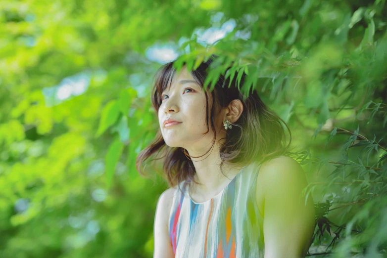 a woman standing in front of a tree, unsplash, shin hanga, chihiro! fujisaki, profile image, sleeveless, vibrant greenery