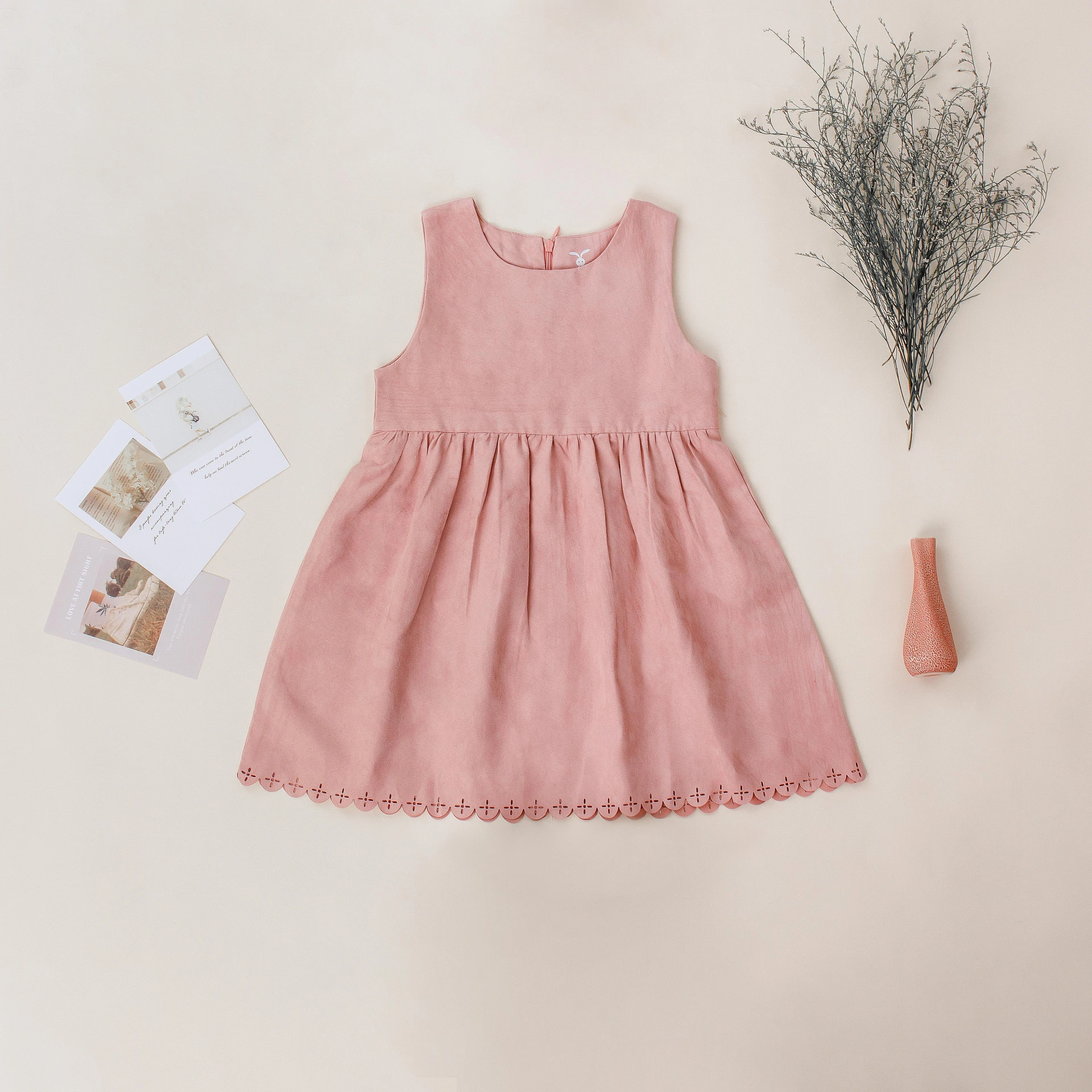 a baby girl's pink dress next to a flower, renaissance, full product shot, ((pink)), pastel pink concrete, lined in cotton