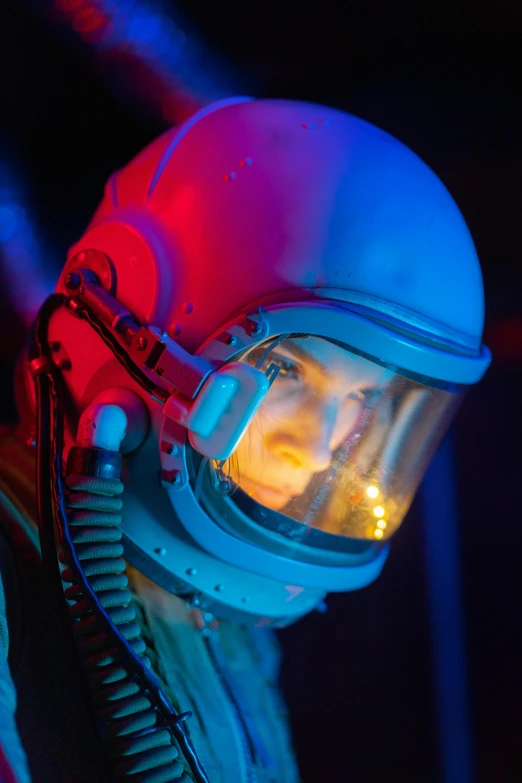 a close up of a person in a space suit, by Dan Luvisi, red and blue lighting, production photo, 70's jetfighter pilot, photographed for reuters