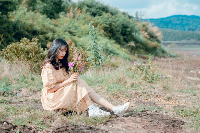a woman sitting on the ground holding a bunch of flowers, a picture, by Tan Ting-pho, unsplash, romanticism, simple cream dress, avatar image, ulzzang, in nature