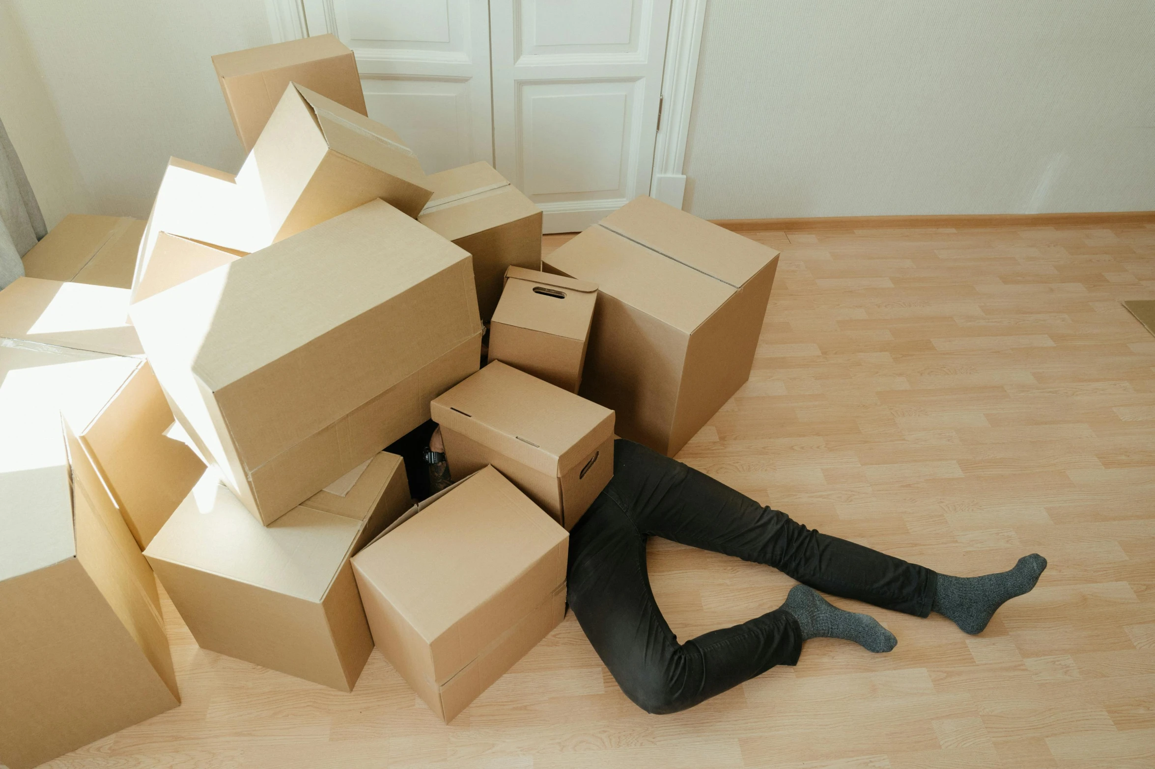 a man laying on the floor surrounded by boxes, inspired by Sarah Lucas, pexels contest winner, temporary art, heartbroken, animation, videogame still, [ forgetful ]