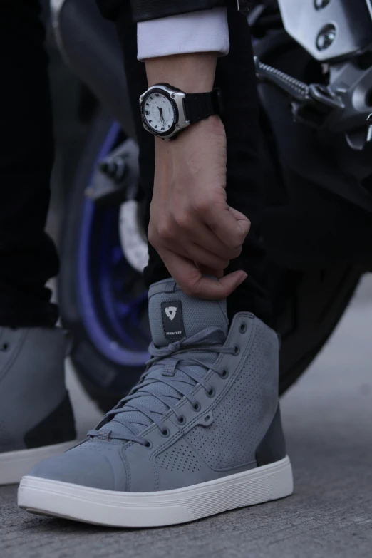 a close up of a person tying a shoe on a motorcycle, alien grey, supra, gentleman, tungsten