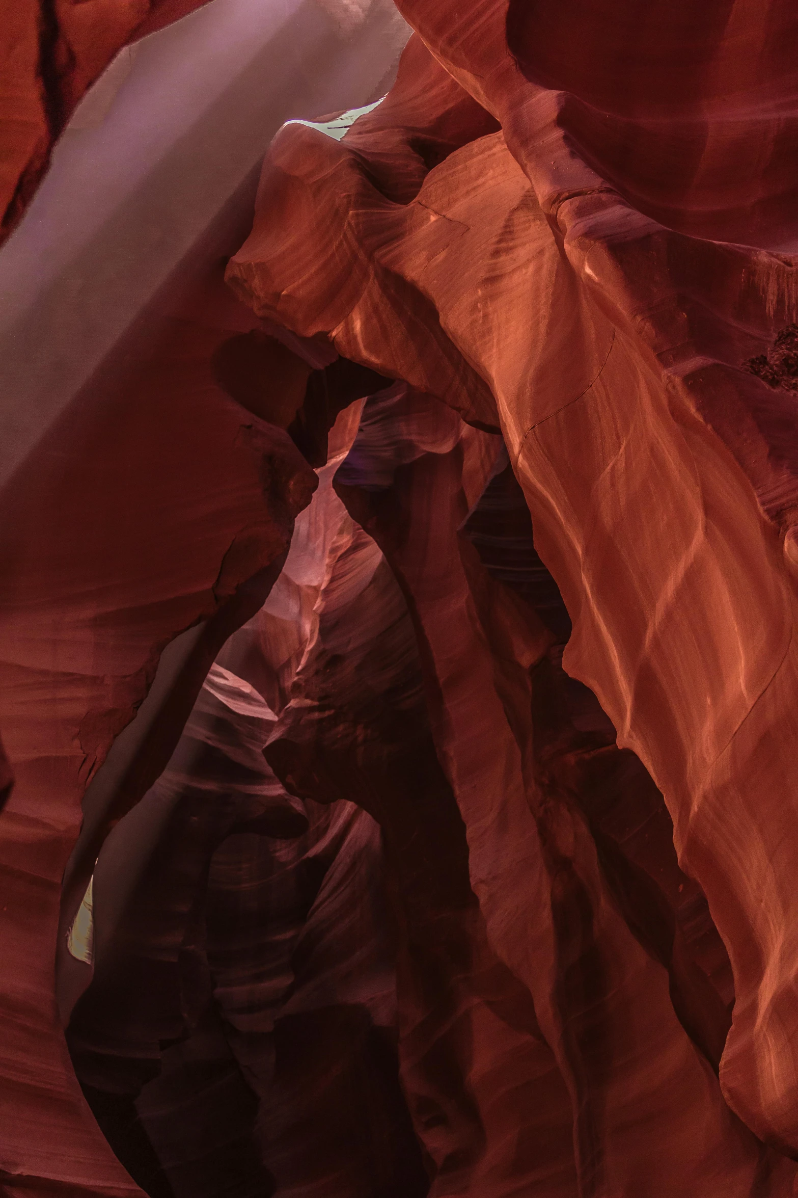 a man standing in the middle of a canyon, by Jessie Algie, pexels contest winner, abstract expressionism, reddish, folds, shafts of light, sculptured