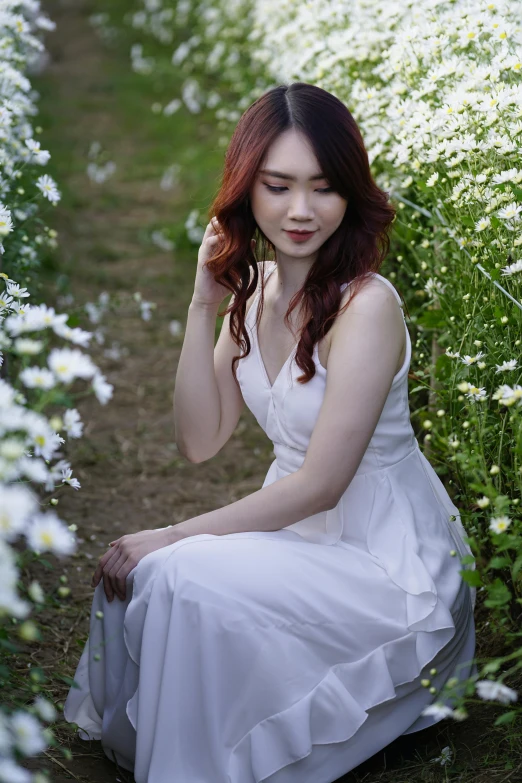 a woman in a white dress sitting in a field of flowers, inspired by Xie Sun, pexels contest winner, japanese model, with pale skin, medium format. soft light, casual pose