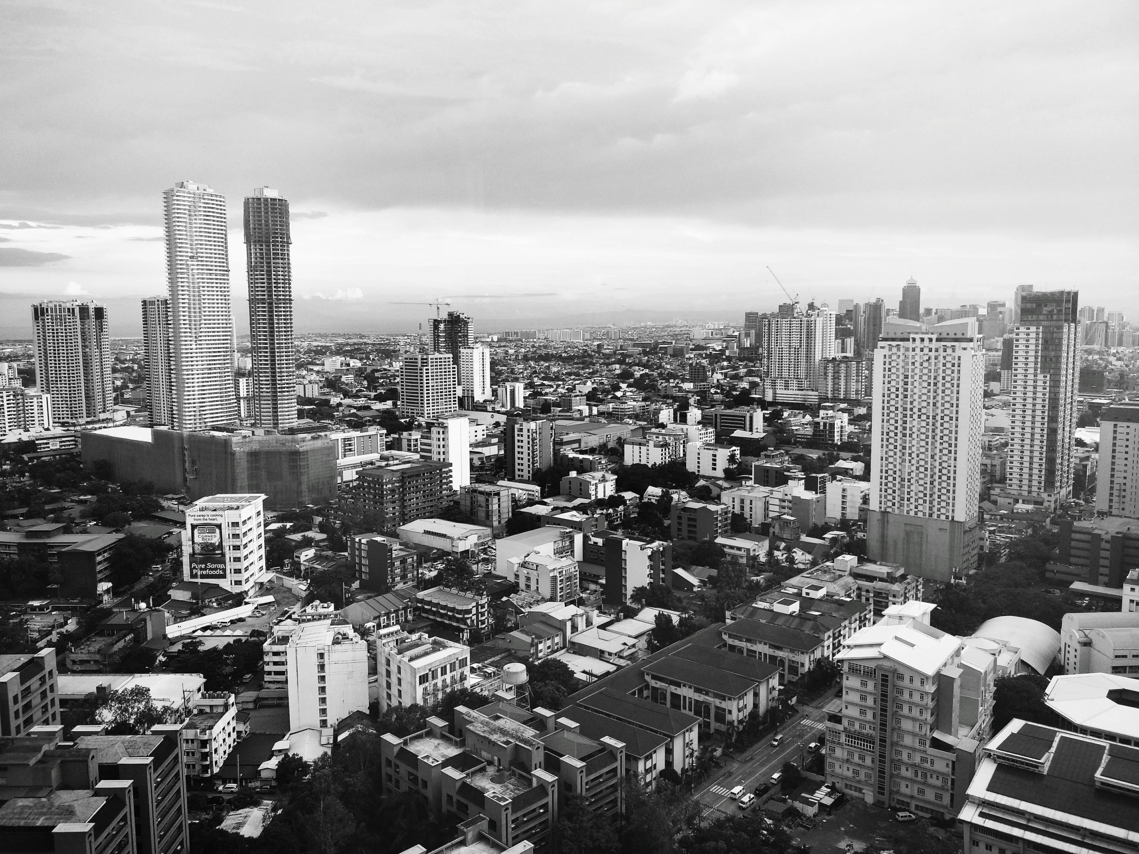 a black and white photo of a city, a black and white photo, manila, skyscapers, instagram post, high angle view