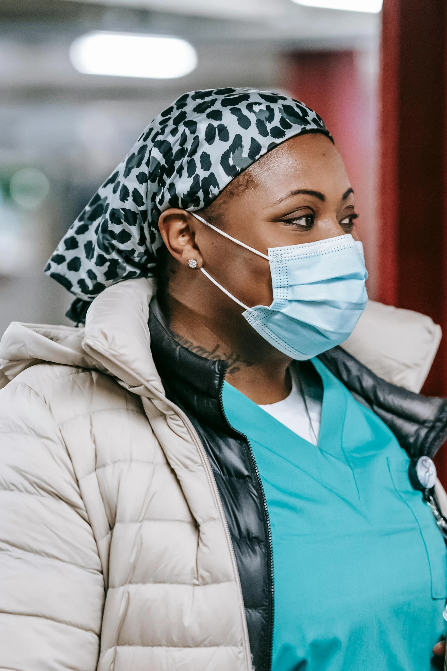 a woman wearing a face mask and gloves, a picture, trending on pexels, healthcare worker, looking to the side off camera, nyc, african woman