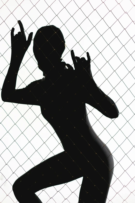 a silhouette of a woman standing in front of a fence, an album cover, figuration libre, sexy pudica pose gesture, trending on imagestation, [ metal ], hand gesture