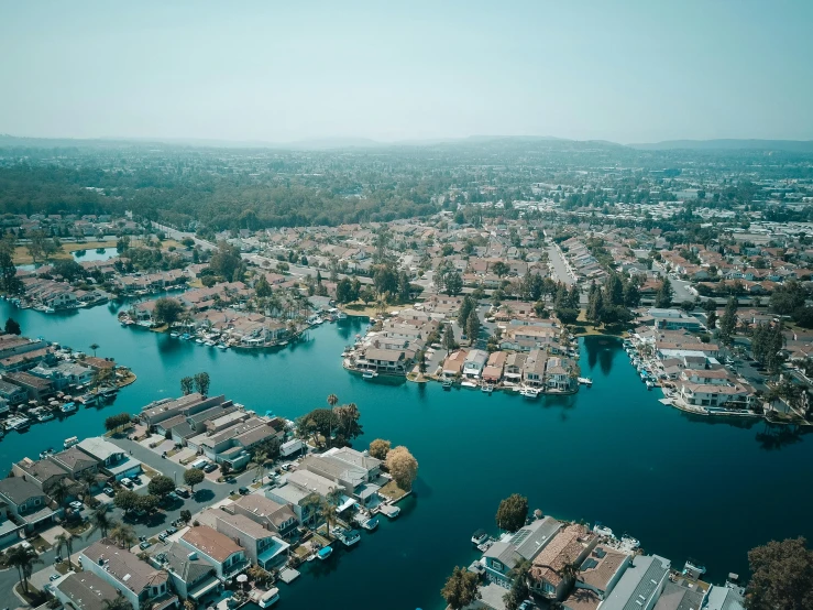 a large body of water surrounded by lots of houses, by Ryan Pancoast, pexels contest winner, central california, cinematic footage, lake view, suburban neighborhood