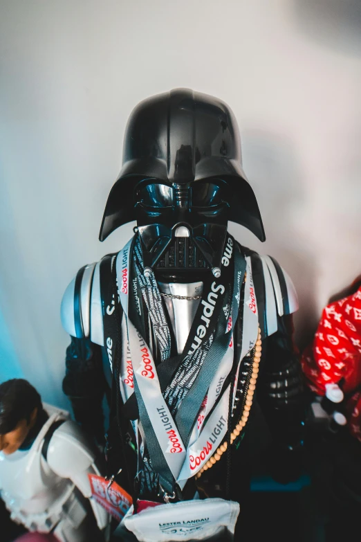 a group of people standing next to a darth vader statue, unsplash, neo-dada, small vials and pouches on belt, close - up portrait shot, toy photo, wearing shiny breastplate