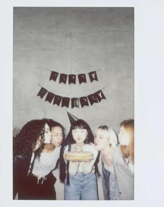 a group of women standing next to each other, a polaroid photo, black hair and white bangs, celebrating a birthday, very very very pale skin, asian descent