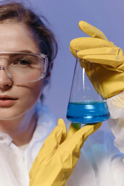 a woman in a lab coat holding a flask, shutterstock, analytical art, yellow and blue and cyan, blue gloves, person in foreground, gen z