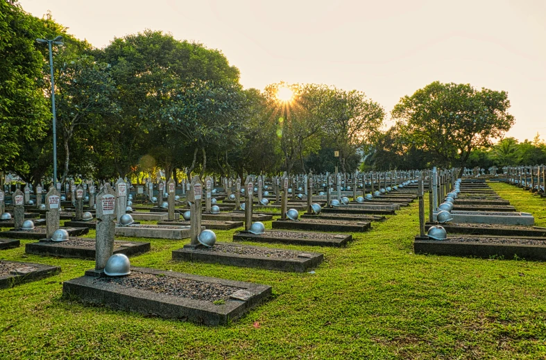 a cemetery filled with lots of tombstones and trees, by Alexander Fedosav, lee kuan yew, golden hour photo, remains