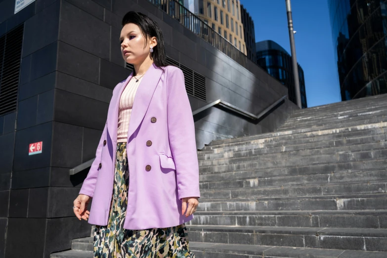 a woman walking down a flight of stairs, a portrait, trending on pexels, wearing a purple detailed coat, wearing jacket and skirt, standing on rooftop, pokimane