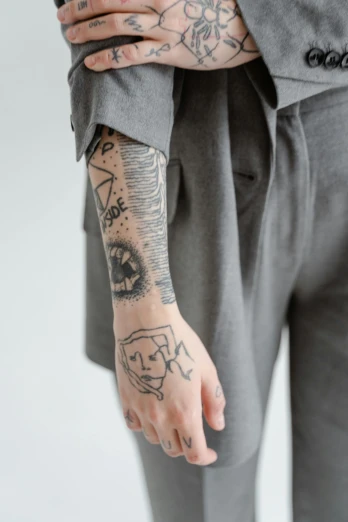 a person with a tattoo on their arm, kacper niepokolczycki, julia hetta, photograph of a sleeve tattoo, pale gray skin