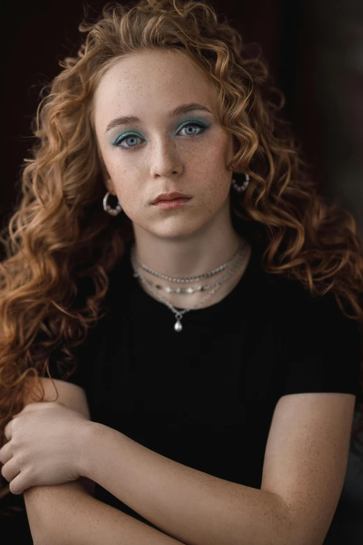 a woman with red hair posing for a picture, an album cover, trending on pexels, photorealism, curly, 1 6 years old, serious look, paul barson