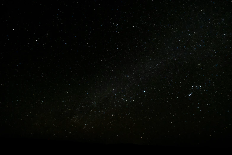 a dark sky filled with lots of stars, a picture, clear skies in the distance, the sky is black, evenly lit, looking towards camera