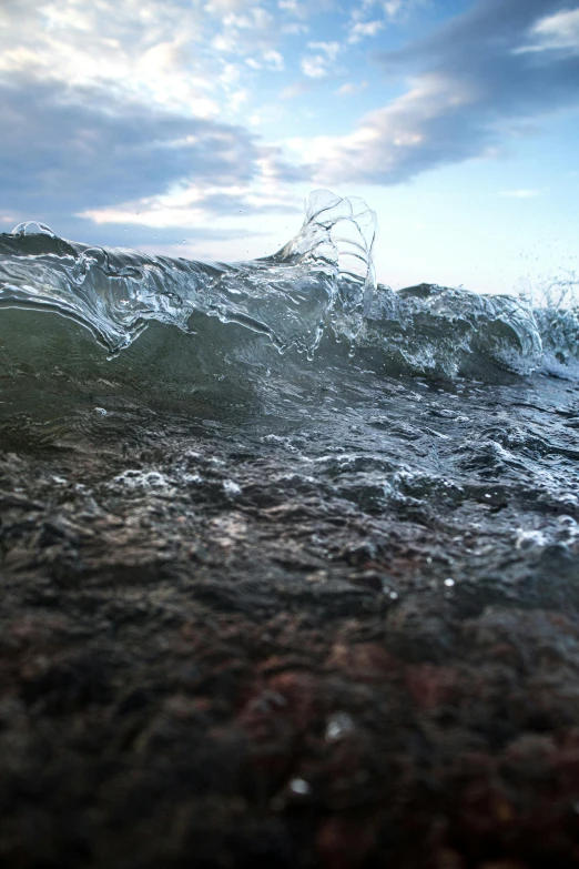 a person riding a surfboard on top of a wave, an album cover, unsplash, photorealism, wet rocks, cycles render 4k, highly detailed photo 4k, real engine 5 cinematic