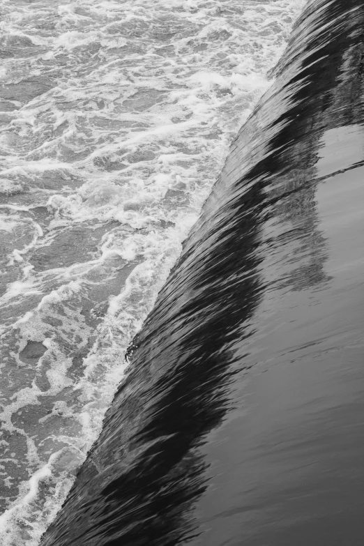 a man riding a wave on top of a surfboard, a black and white photo, inspired by Edward Weston, unsplash, lyrical abstraction, closeup of magic water gate, sewage, ( ( abstract ) ), reflections on the river