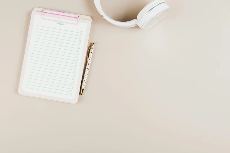 a notepad and headphones on a table, by Carey Morris, trending on pexels, minimalism, light pink background, background image, thumbnail, beige color scheme