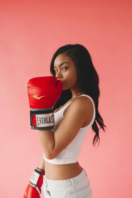 a woman in white shorts and a red boxing glove, an album cover, pexels contest winner, teenage vanessa morgan, vannessa ives, profile image, fist training