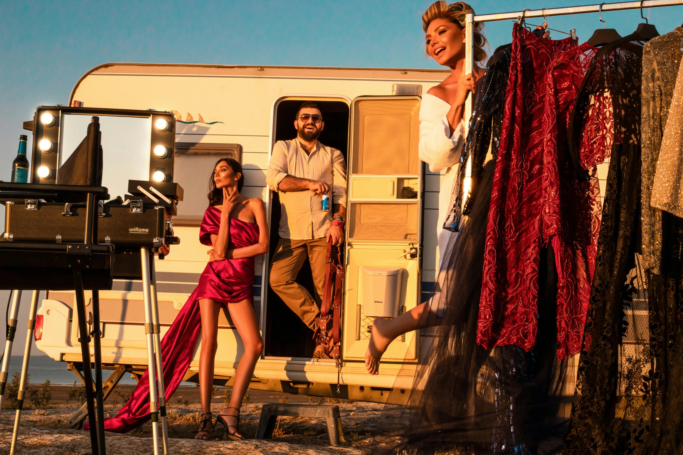 a group of people standing in front of a trailer, pexels contest winner, renaissance, haute couture fashion shoot, camping, 3 actors on stage, during golden hour