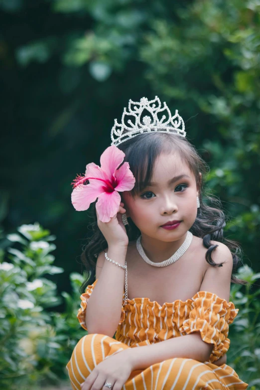 a little girl with a flower in her hair, inspired by reyna rochin, pexels contest winner, sumatraism, wearing a diamond crown, isabela moner, bali, single