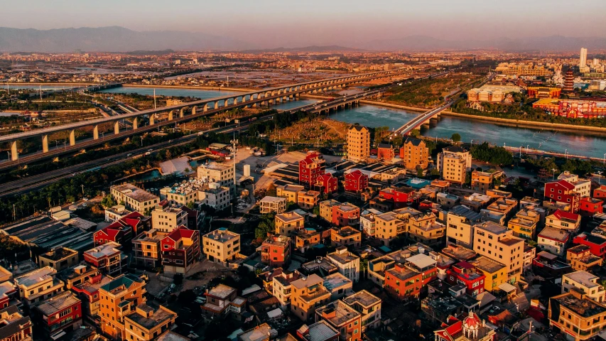 an aerial view of a city with a bridge, pexels contest winner, hurufiyya, shanty town, amr elshamy, paradise in the background, golden hour photo