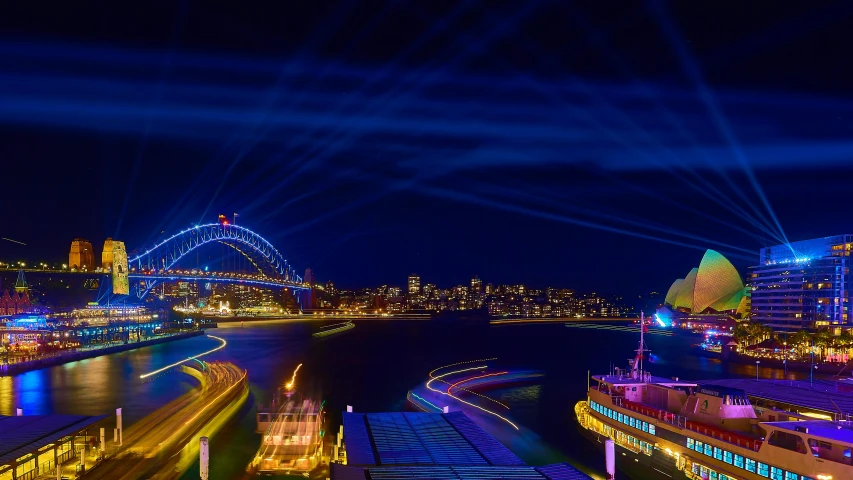 a large body of water with a bridge in the background, a hologram, by Lee Loughridge, pexels contest winner, hurufiyya, harbour, extreme panoramic, music festival, blue and orange rim lights