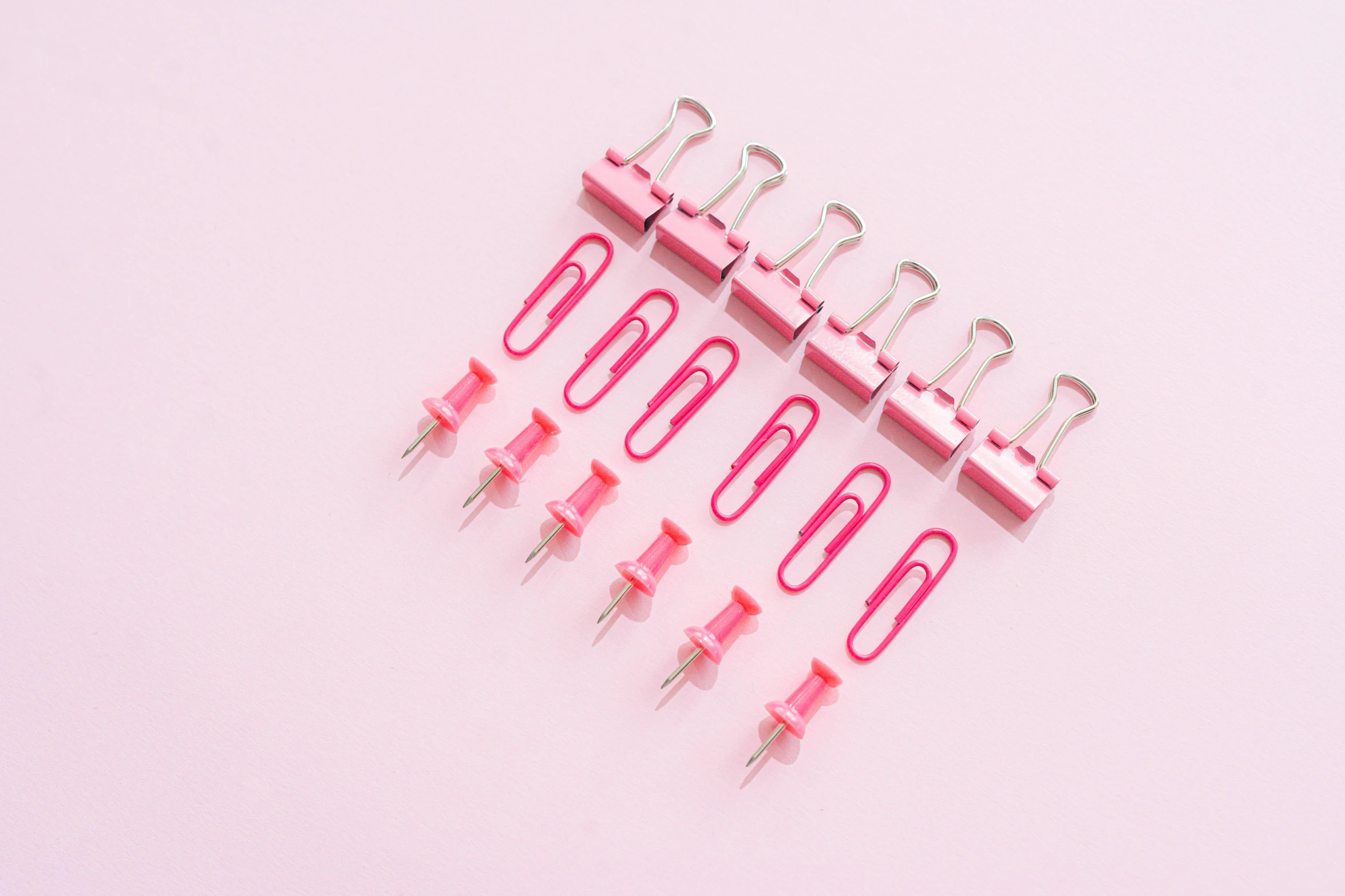 a bunch of pink clips sitting on top of a white surface, pexels, ((pink)), eight eight eight, clamp, desktop wallpaper