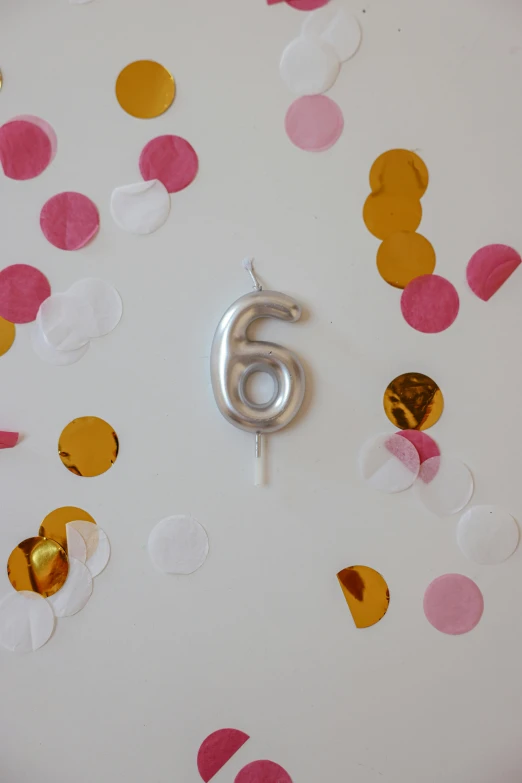 a white plate topped with a number six surrounded by confetti, waxy candles, detailed product image, satin silver, - 6