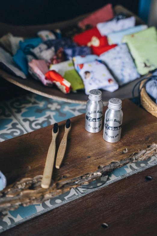 a table topped with plates of food and utensils, by Julia Pishtar, unsplash, bottles covered in wax, pair of keycards on table, for kids, close-up product photo