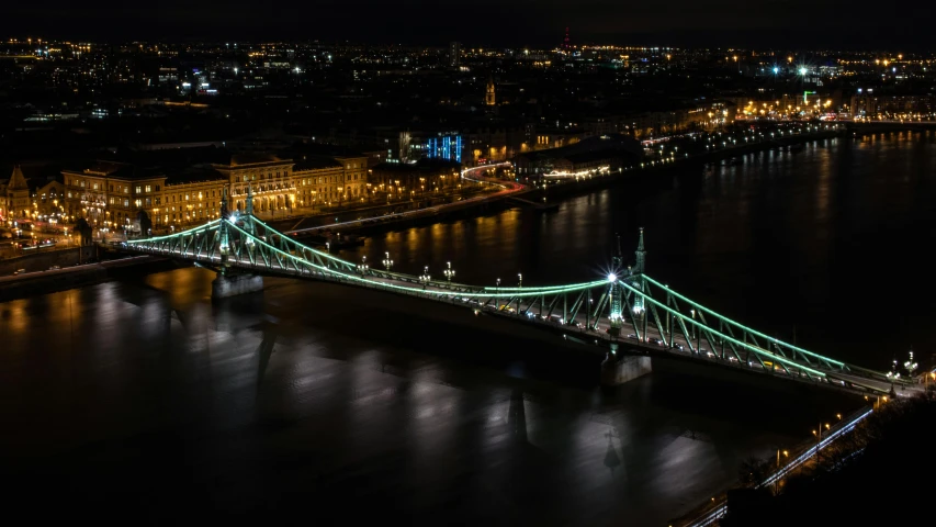a bridge over a body of water at night, by Adam Szentpétery, pexels contest winner, photo of green river, parliament, gigapixel photo, thumbnail