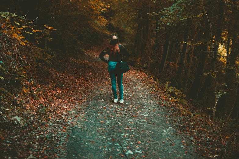 a woman walking down a path in the woods, pexels contest winner, happening, lo - fi colors, teenage girl, autumnal, back turned