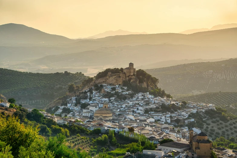 a view of a town from the top of a hill, inspired by Serafino De Tivoli, pexels contest winner, jerez, white, mountainous, at sunrise