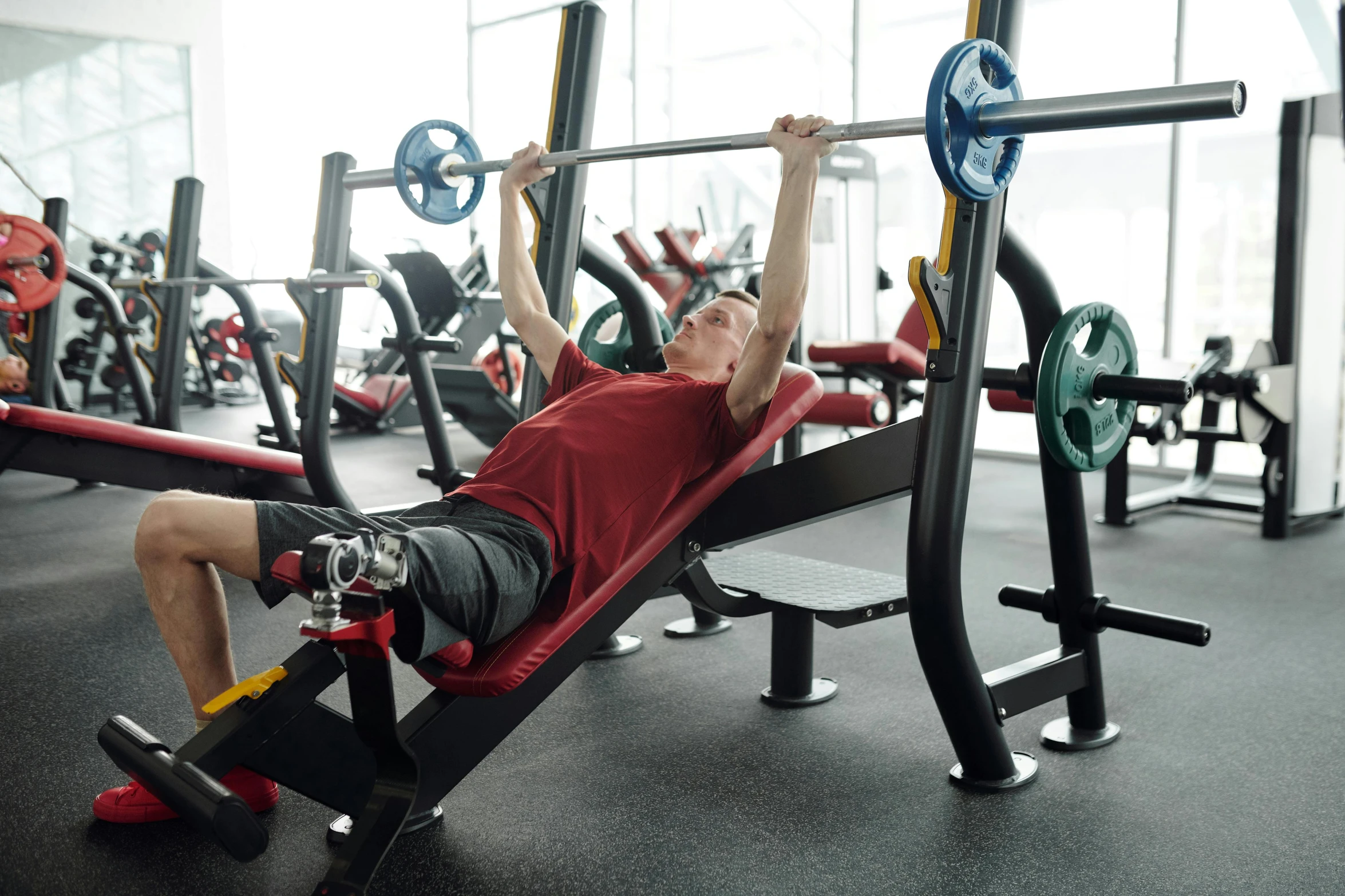 a man laying on a bench in a gym, trending on pexels, train with maroon, old man doing hard work, manuka, museum quality photo