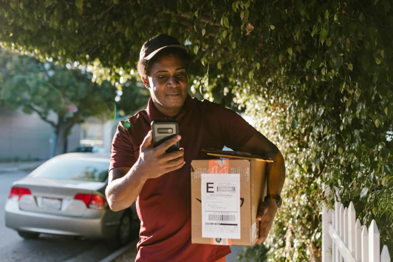 a man holding a box and a cell phone, bay area, profile image, essence, nearest neighbor