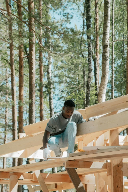 a man sitting on top of a wooden structure, jaylen brown, roofed forest, bradbuilds, profile image