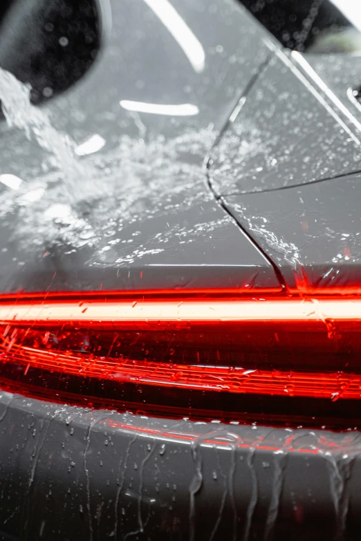 a close up of a car's tail light, process art, water light scattering, with a sleek spoiler, thumbnail, multi-part