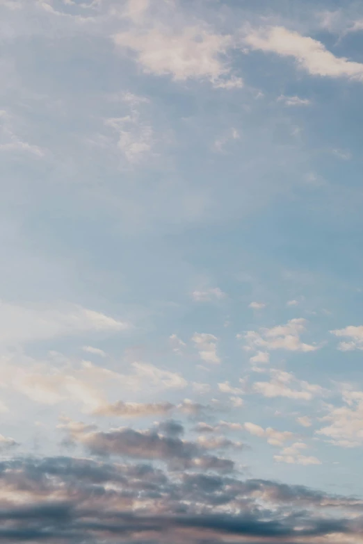 a man riding a snowboard on top of a snow covered slope, a picture, unsplash, minimalism, fluffy pastel clouds, late summer evening, soft light - n 9, looking up into the sky