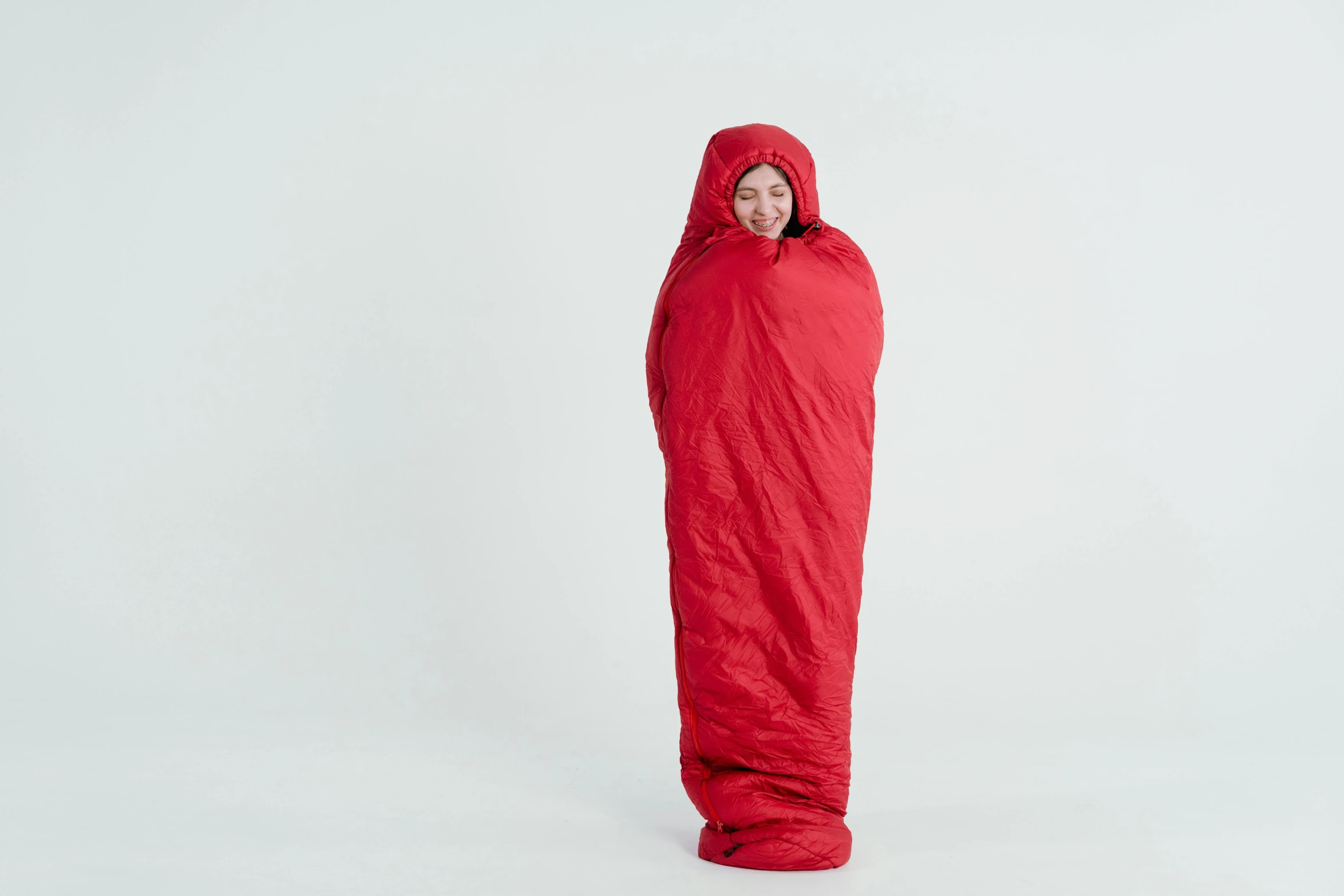 a woman wrapped up in a sleeping bag, inspired by Okada Hanko, arte povera, red, medium wide shot, ultra realistic, lightweight