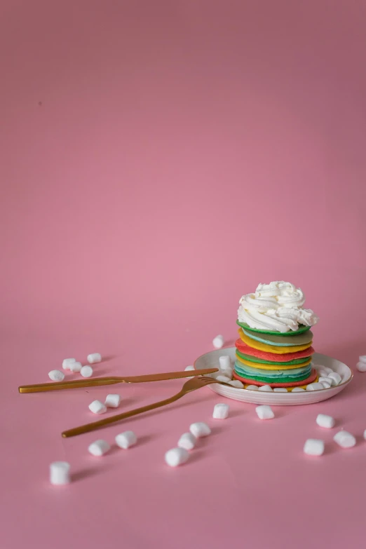 a cupcake sitting on top of a plate with marshmallows, inspired by Peter Alexander Hay, color field, pancakes, stacked, color block, curated collection