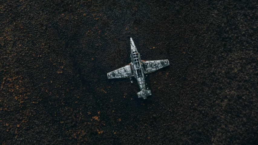 an airplane that is sitting in the dirt, by Jesper Knudsen, unsplash contest winner, pixel art, valkyrie fighter jet, mini model, camouflage, dark and white