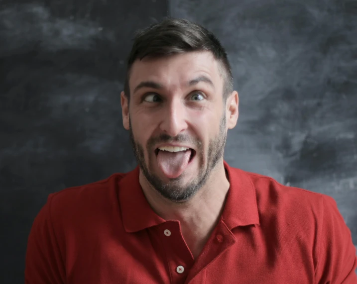 a man in a red shirt making a funny face, pexels contest winner, renaissance, zachary corzine, all overly excited, square masculine jaw, manly face