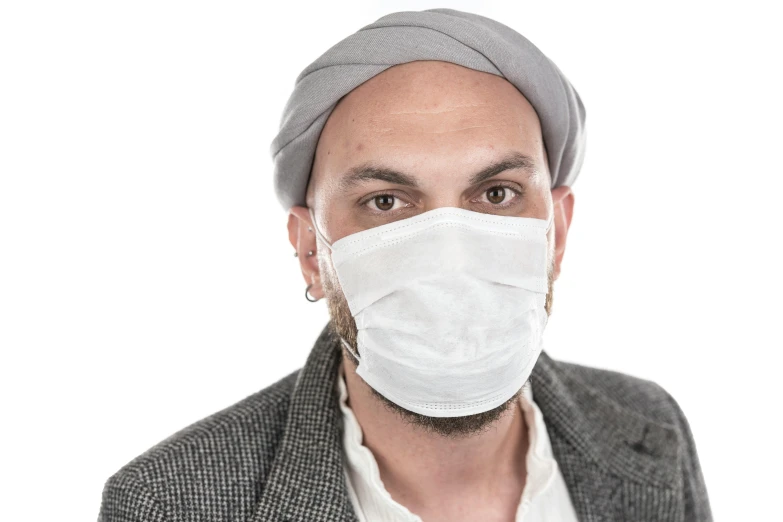 a man wearing a face mask in front of a white background, shutterstock, antipodeans, turban, dressed in an old white coat, grey, commercial