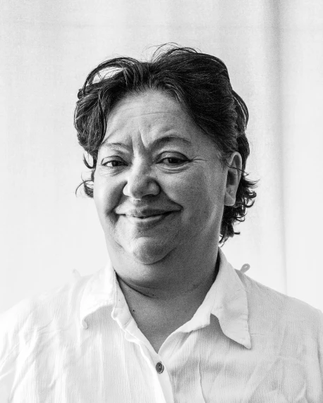 a black and white photo of a woman smiling, a black and white photo, pablo perdomo, a portrait of a plump woman, lgbtq, official government photo