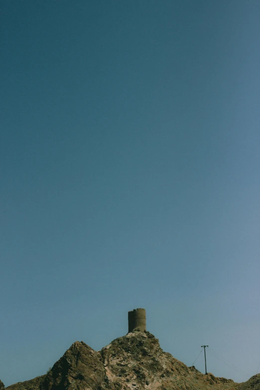 a man flying a kite on top of a sandy beach, by Peter Churcher, postminimalism, myllypuro water tower, brutalist, totem 2, disolate :: a long shot