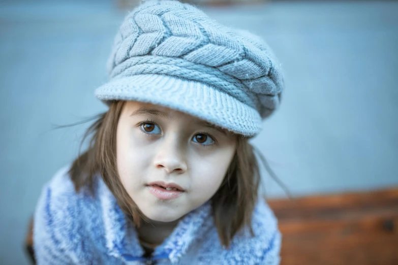 a little girl wearing a hat and scarf, pexels contest winner, blue and grey theme, portrait image, light grey, small hat